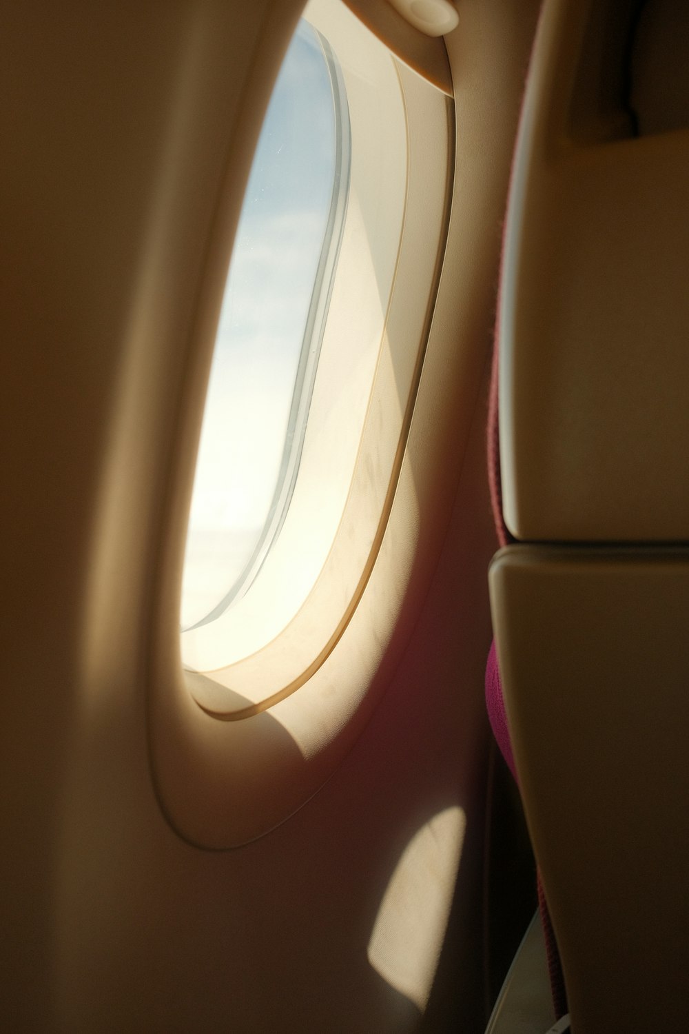 an airplane window with a view of the sky