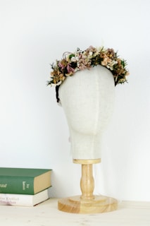 a white mannequin with a flower crown on top of it