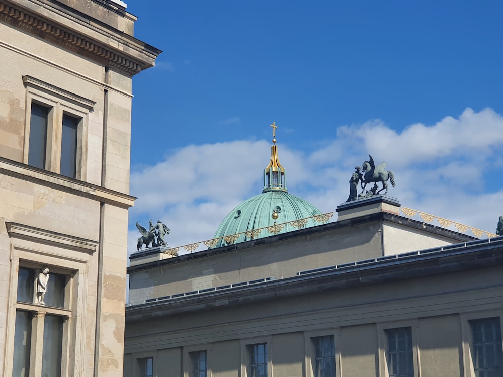 a tall building with a green dome on top of it