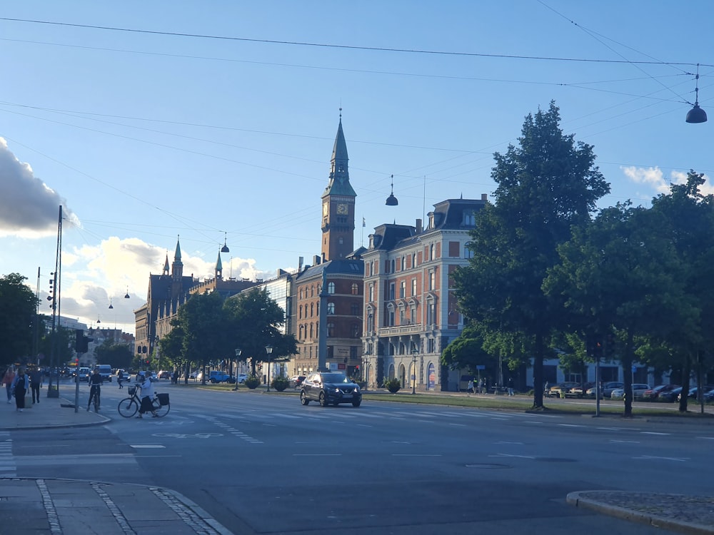 a city street with a clock tower in the background