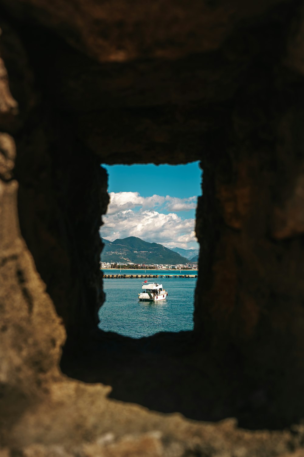 a view of the ocean through a hole in a rock