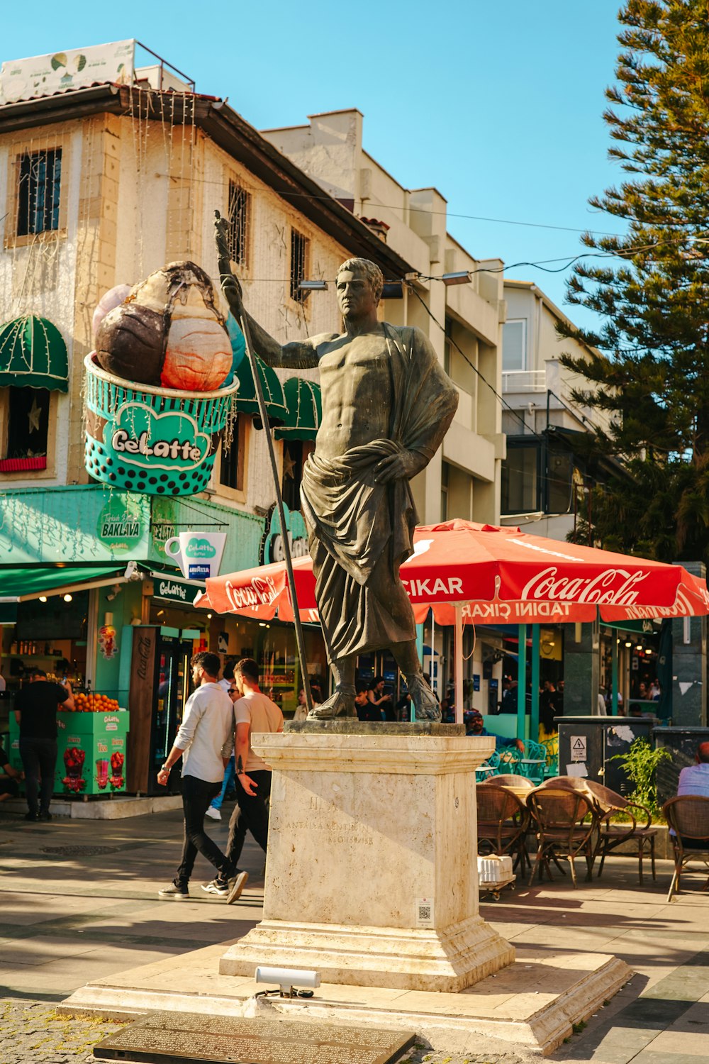 a statue of a man holding an umbrella