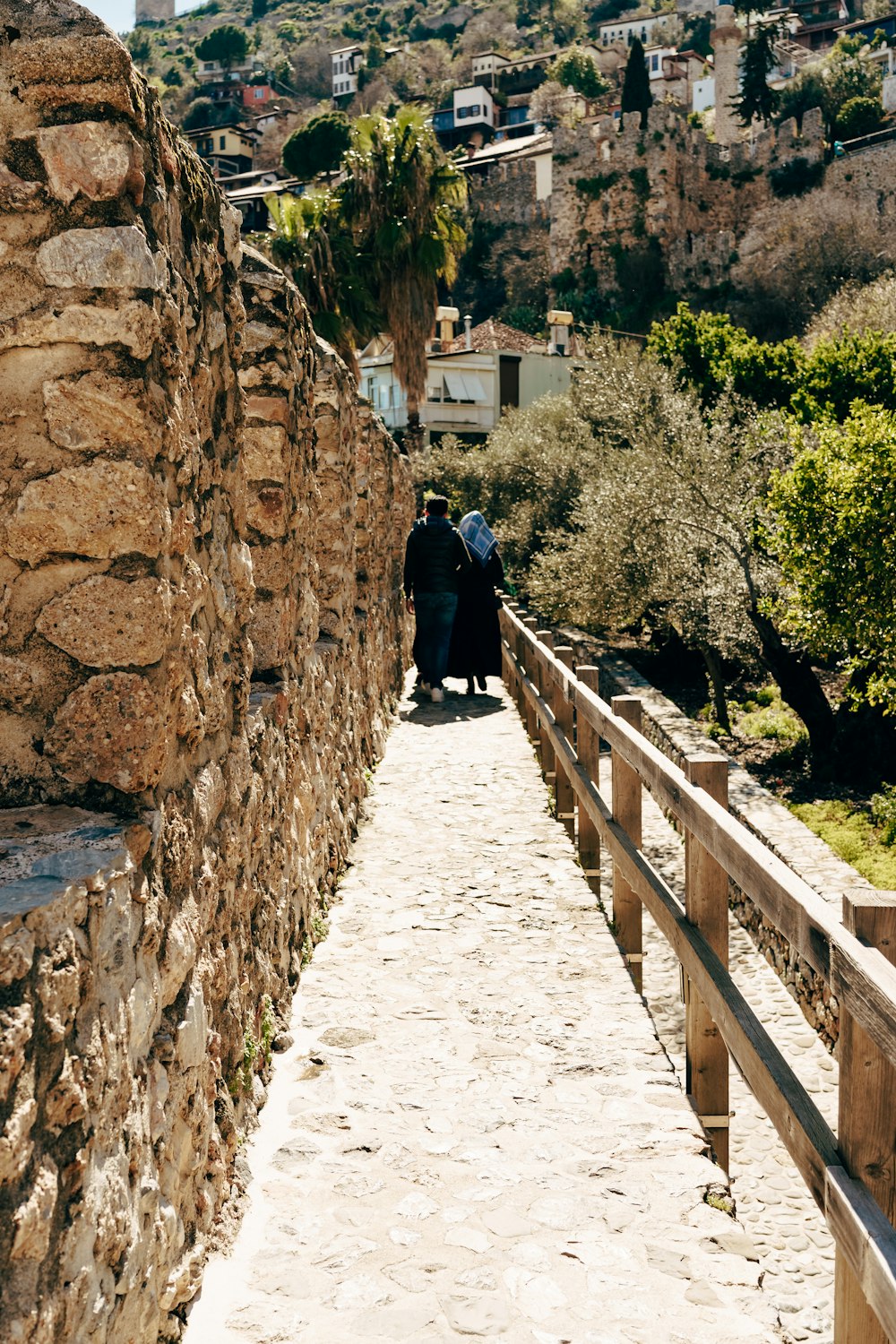 a couple of people that are walking down a path