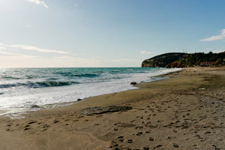 a sandy beach with footprints in the sand