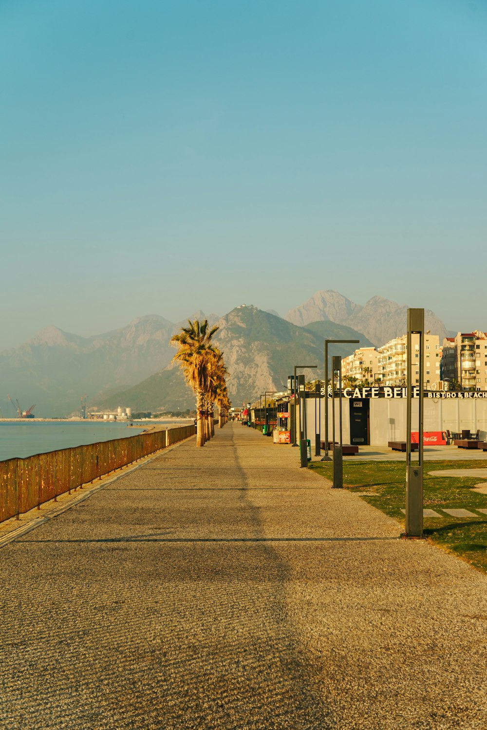 a long walkway next to a body of water