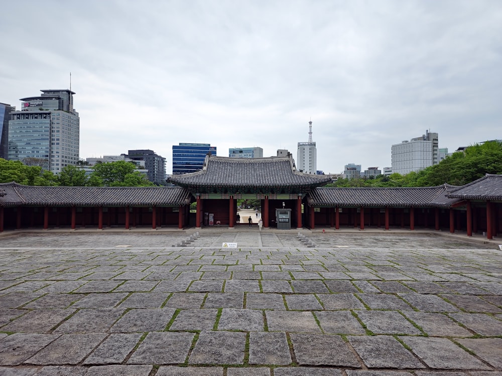 a large courtyard with a building in the background