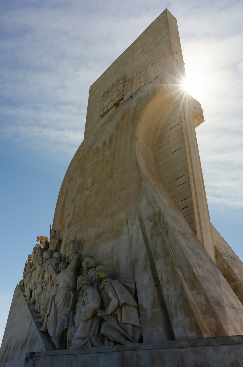 the sun shines brightly behind a monument