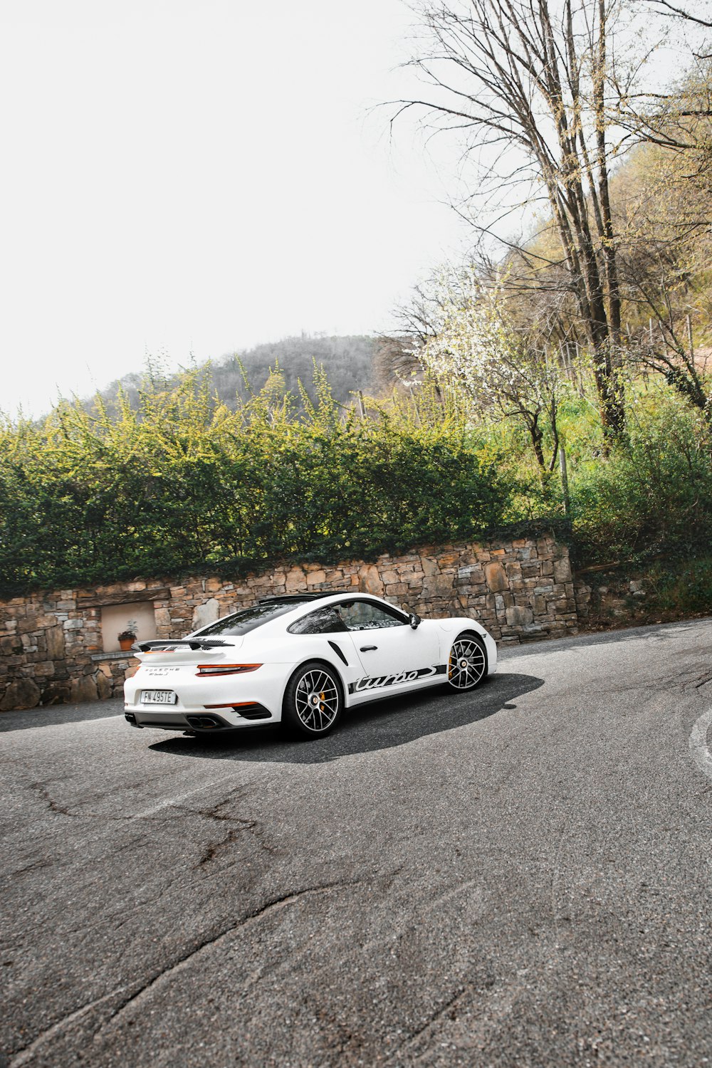 a white sports car parked on the side of a road