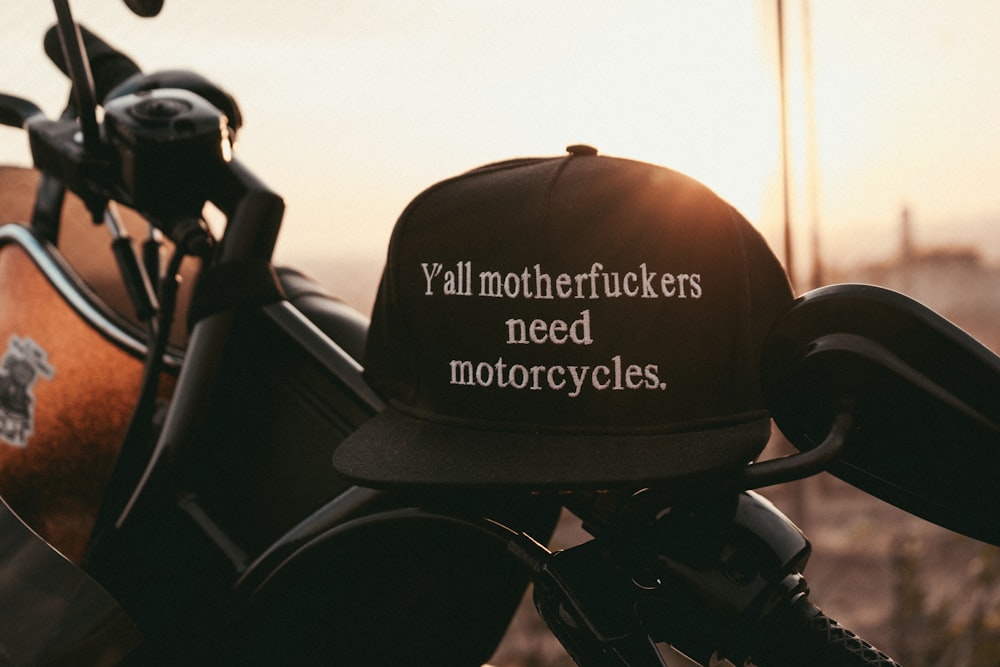 a hat that is sitting on top of a motorcycle