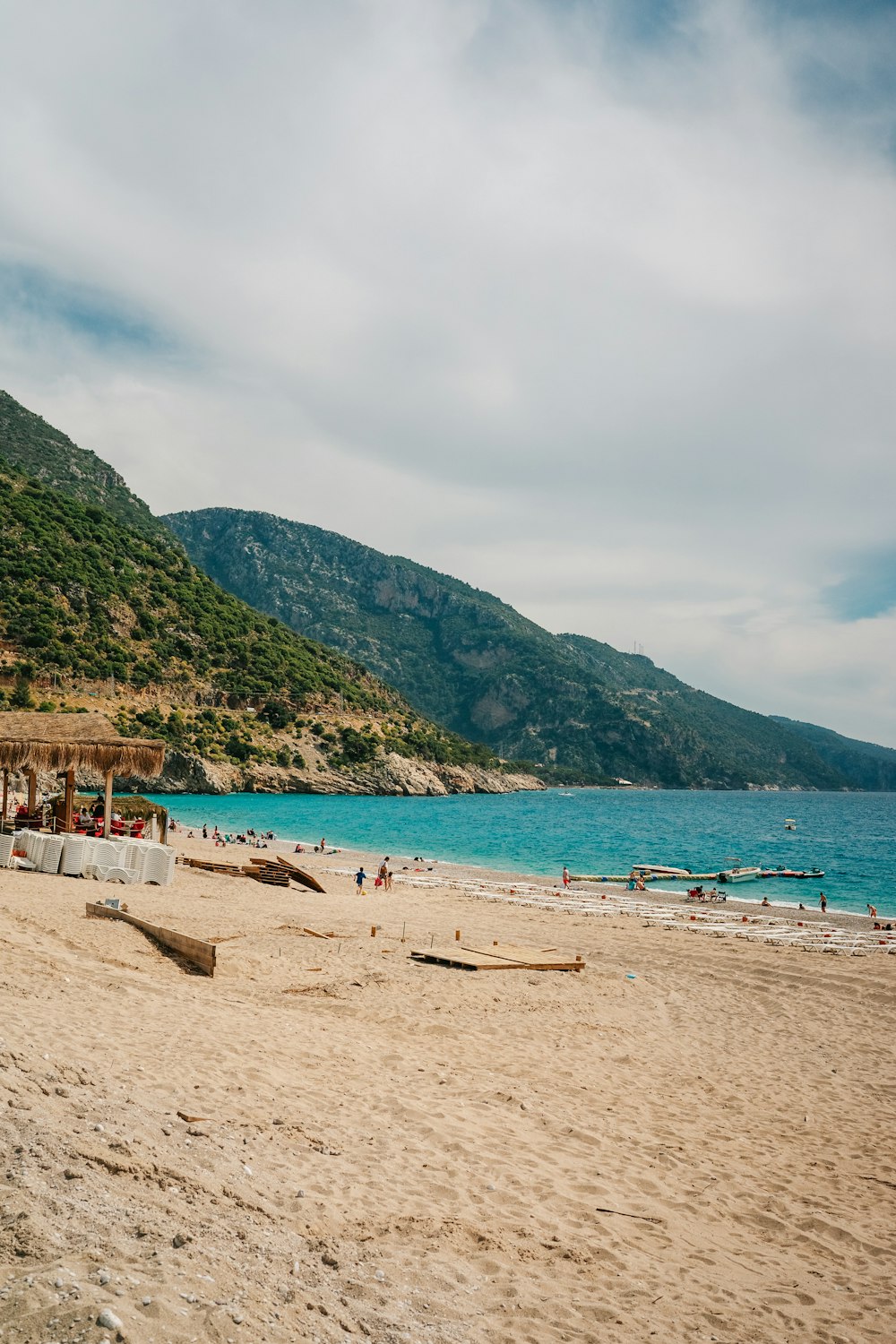 a sandy beach with a mountain in the background