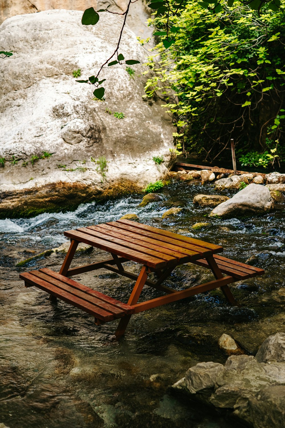 a picnic table sitting on top of a river
