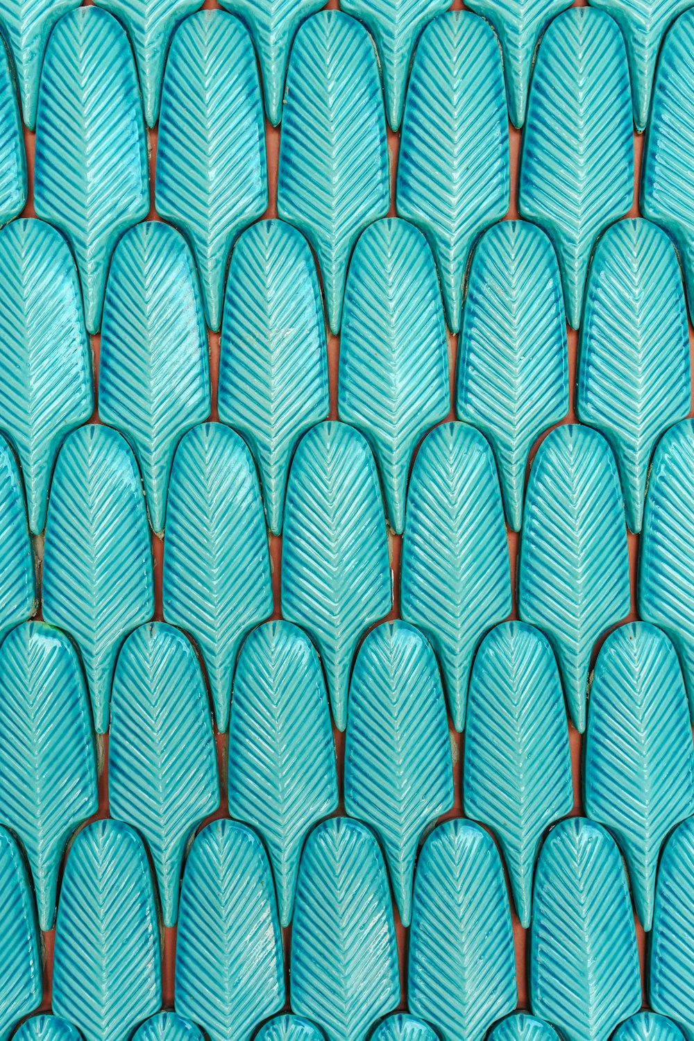 a close up of a pattern of blue leaves