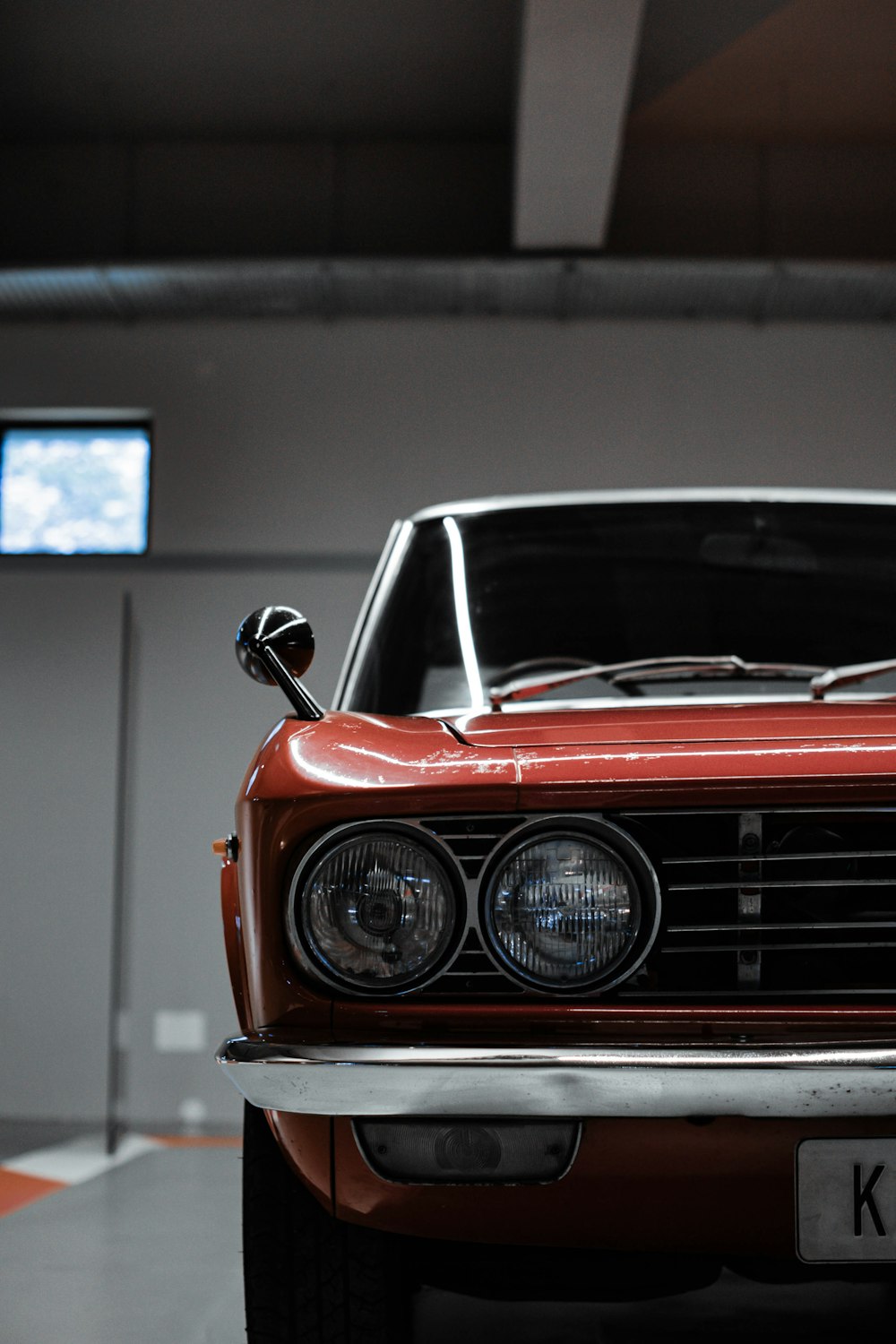 a red car parked inside of a garage