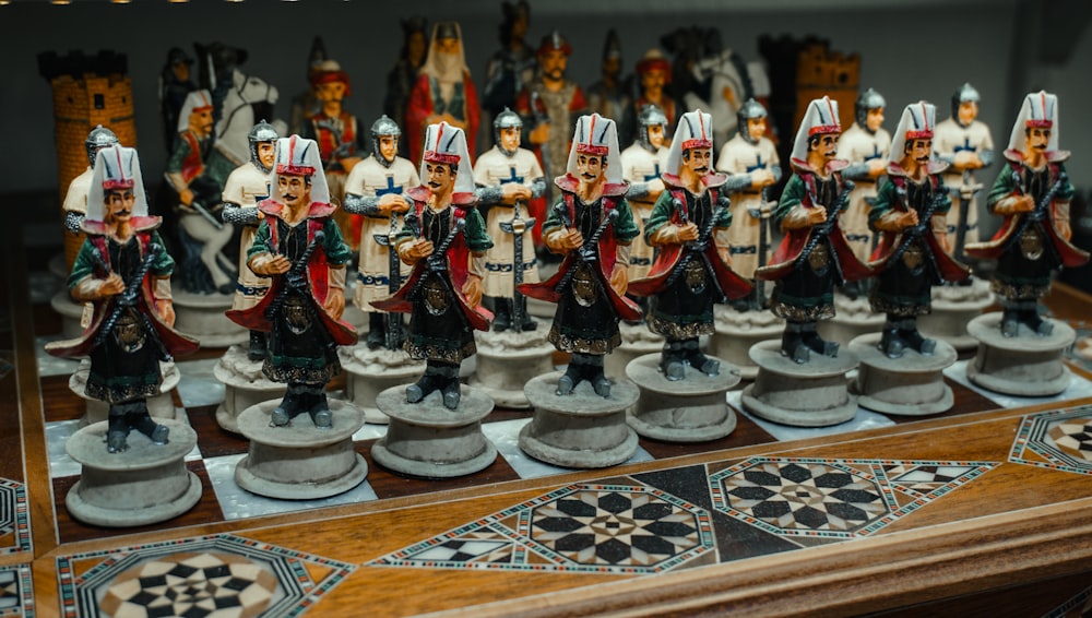 a wooden table topped with lots of figurines