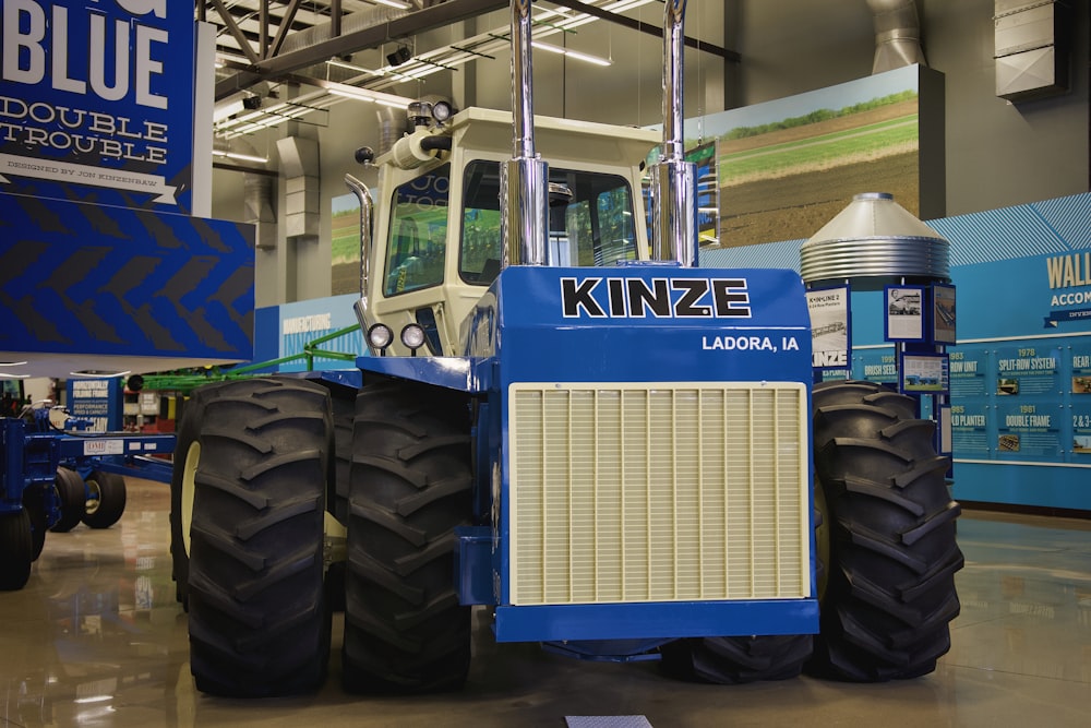 a large blue tractor parked inside of a building
