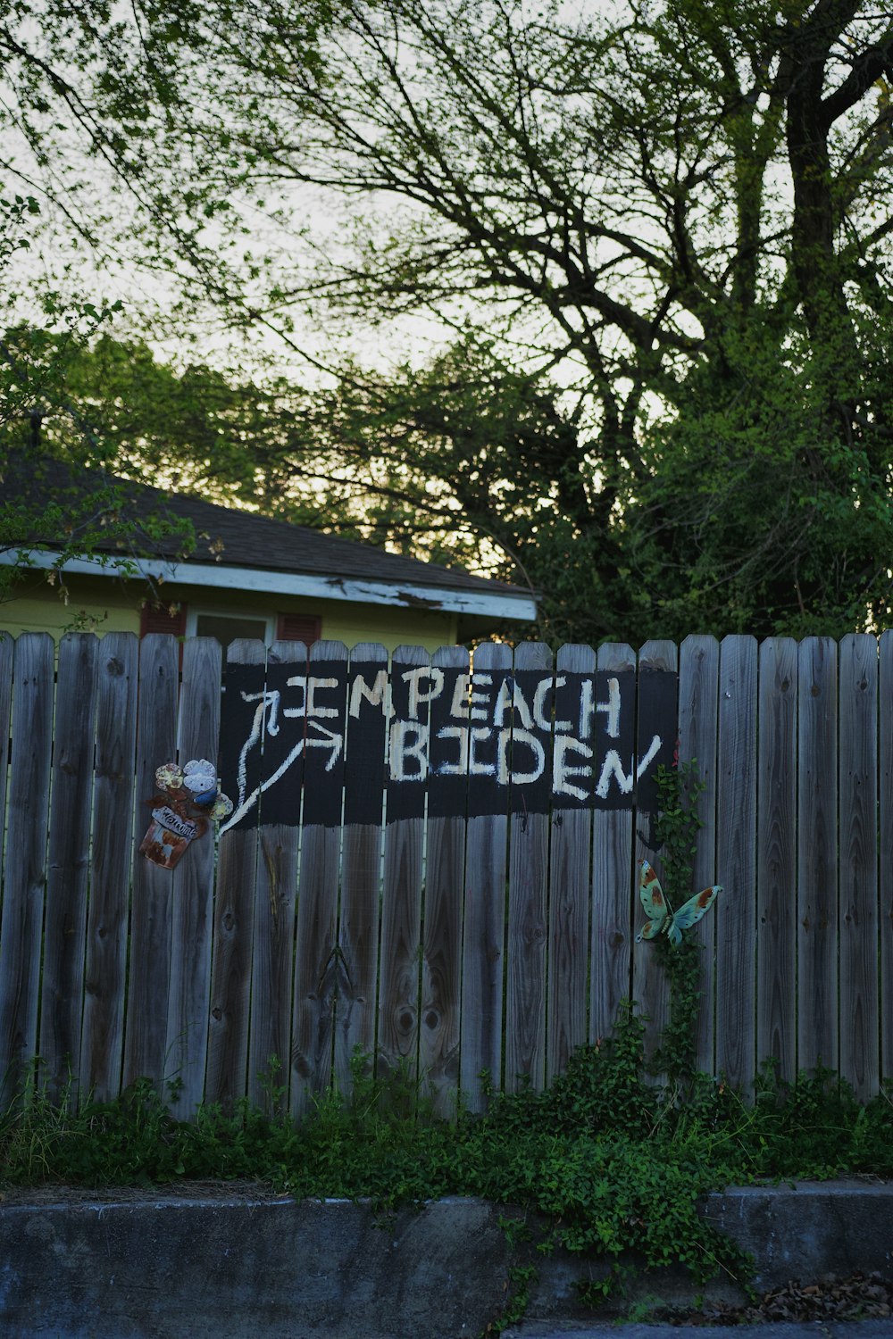 a wooden fence with graffiti written on it