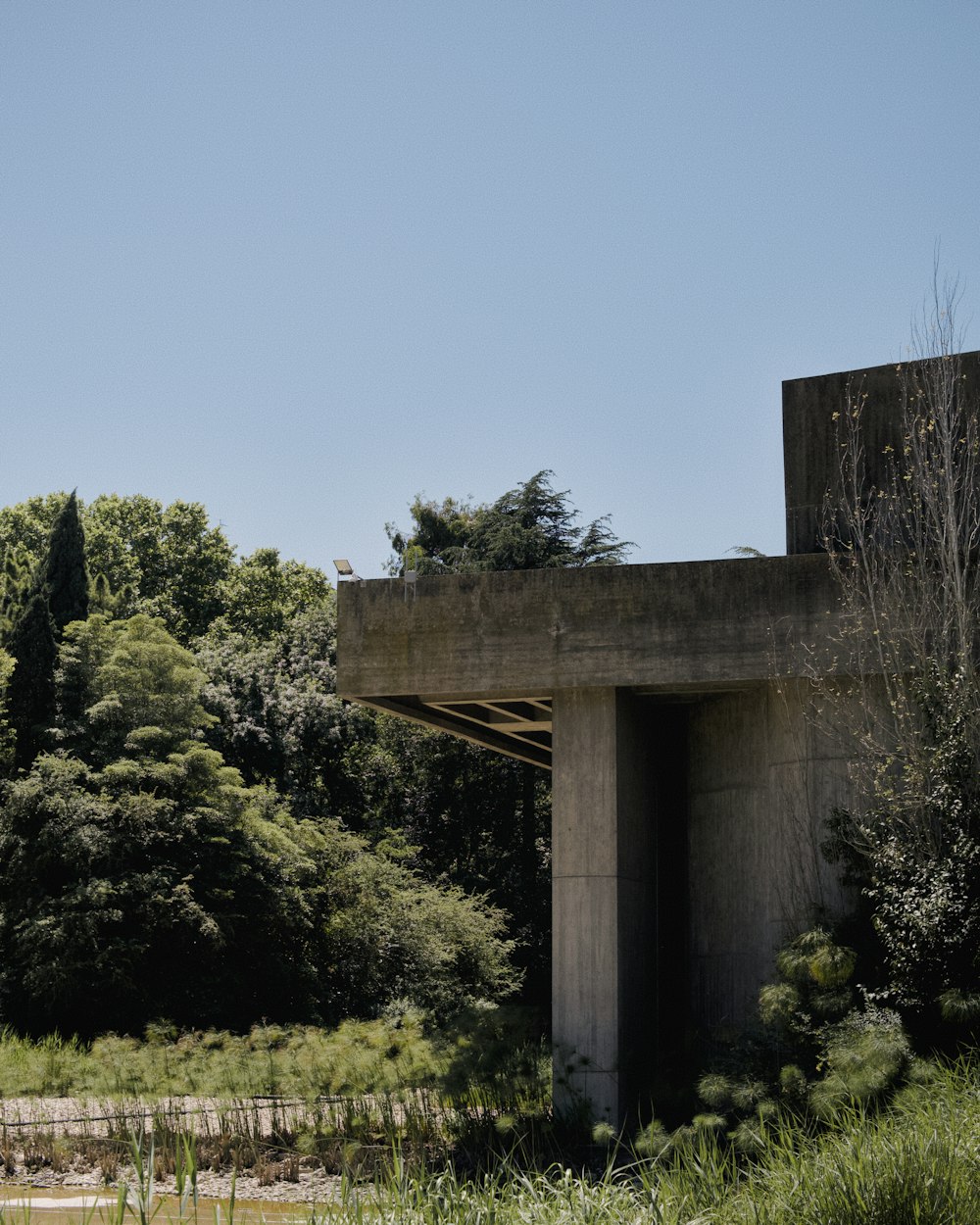a concrete structure with trees in the background