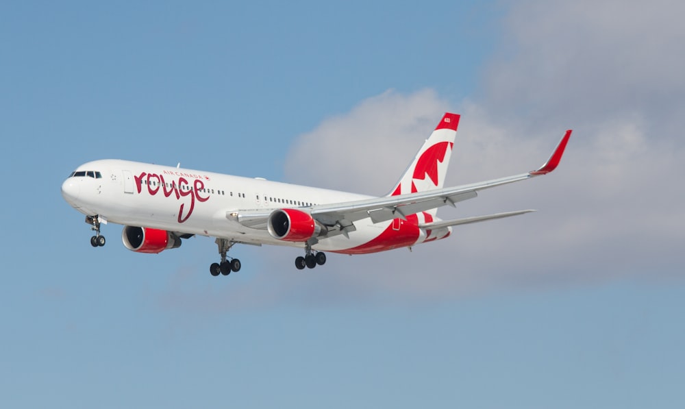 a large passenger jet flying through a blue sky