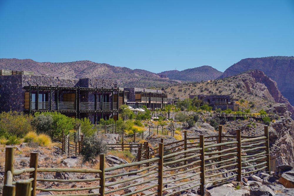 a wooden fence in front of a mountain