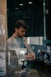 a man is looking at his cell phone