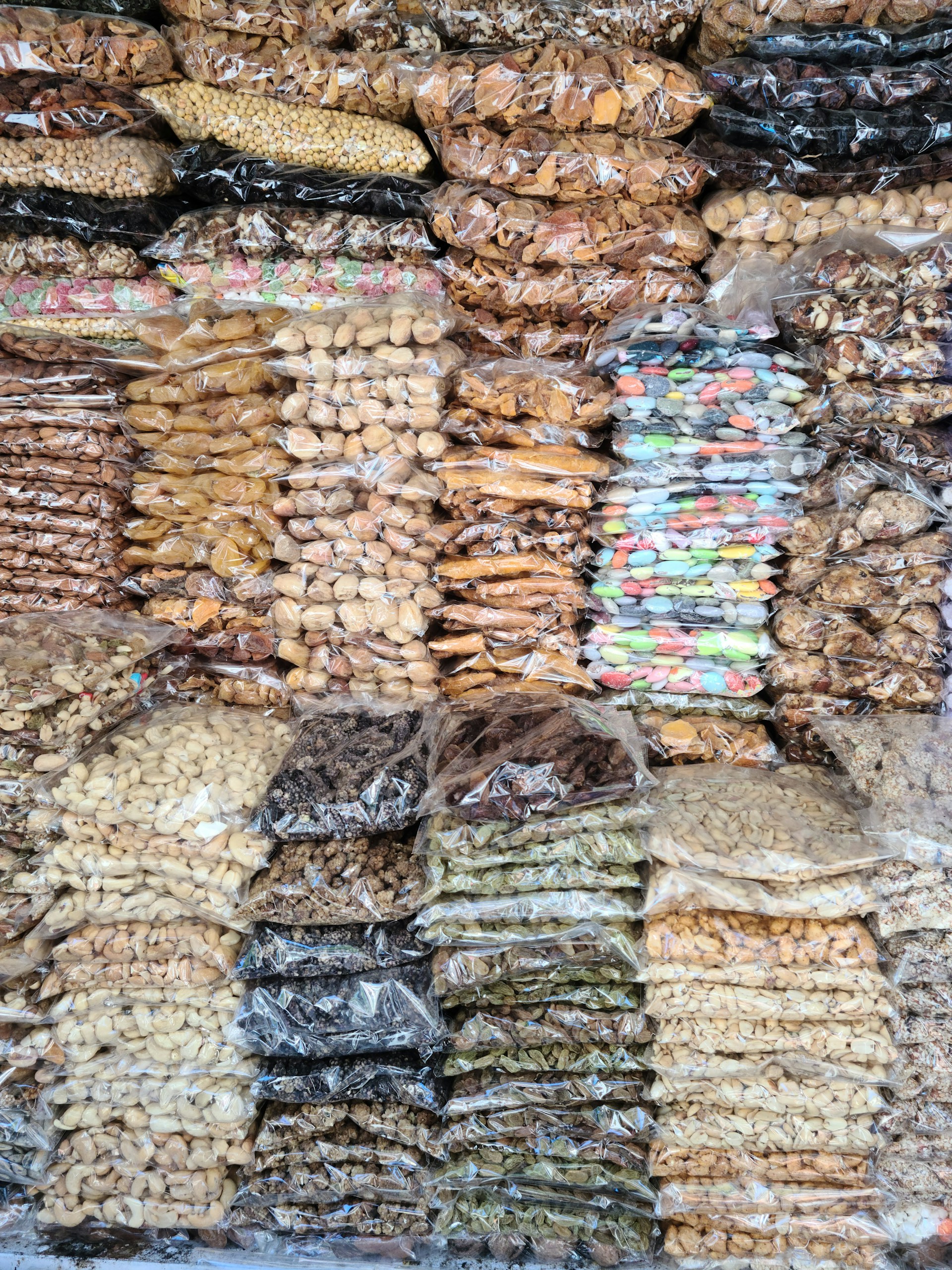 a pile of bags of food sitting on top of a table