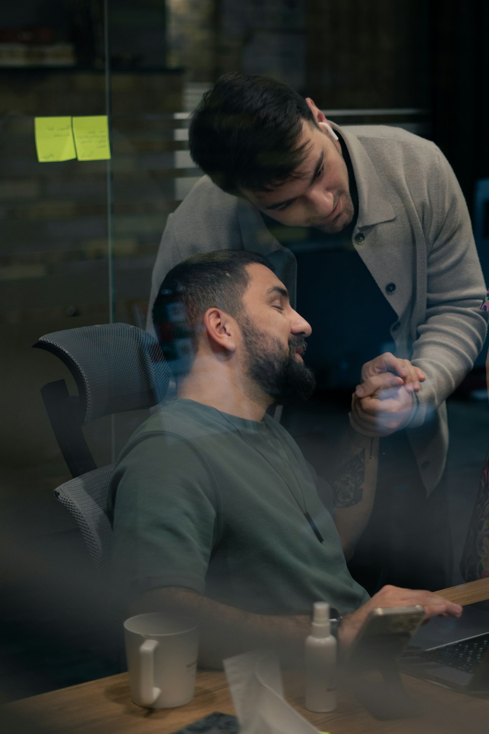 a man sitting in front of a laptop computer