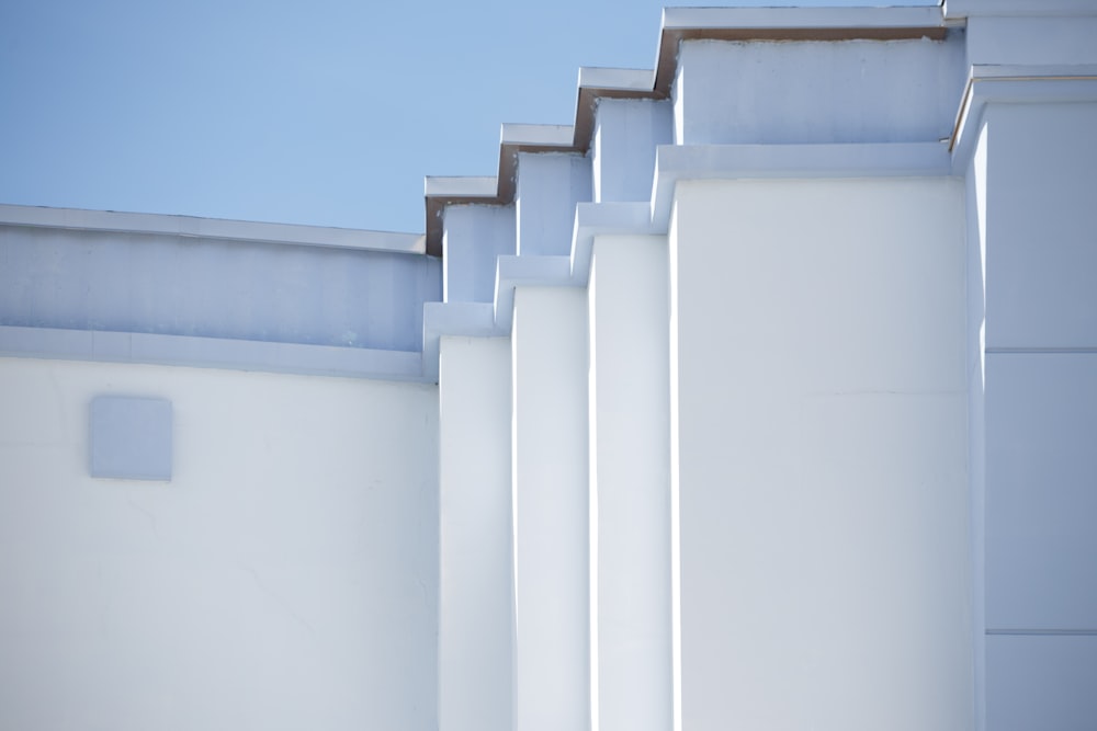 a row of white buildings with a blue sky in the background