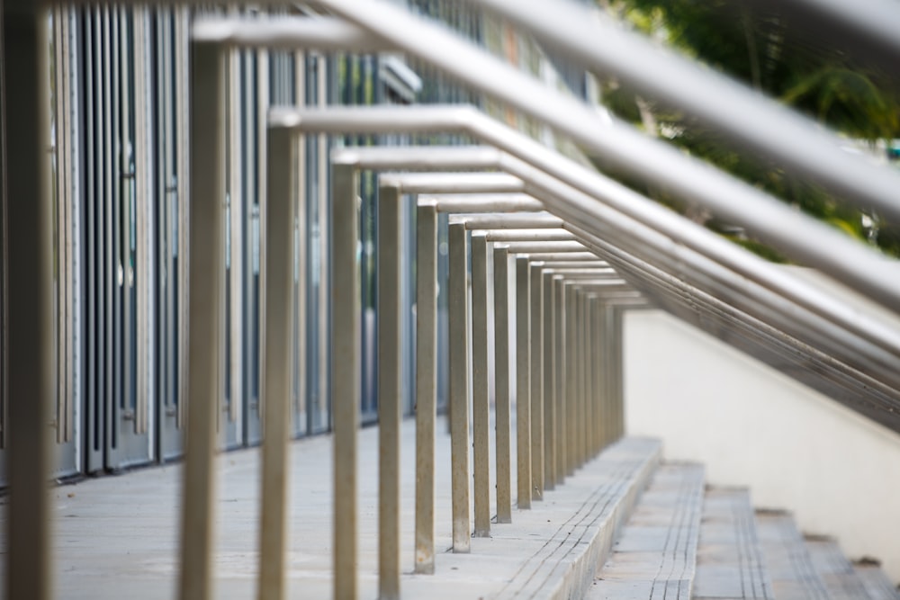 a row of metal railings next to a building