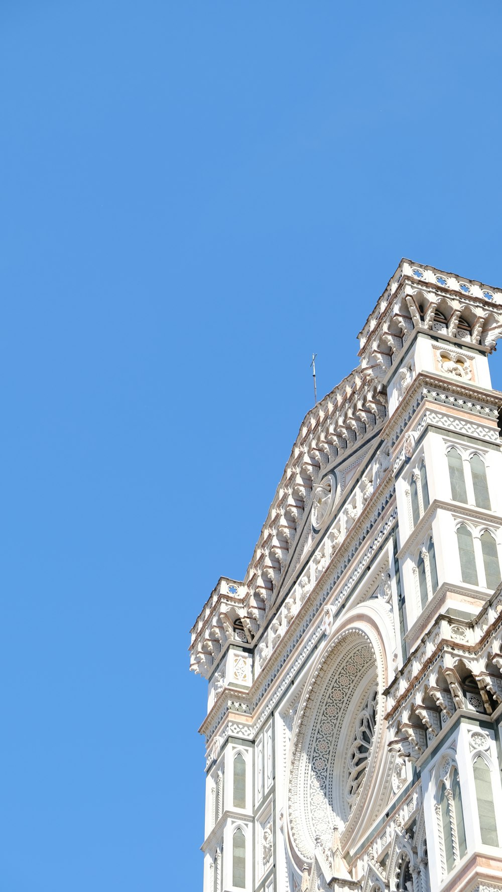 a tall white building with a clock on it's side