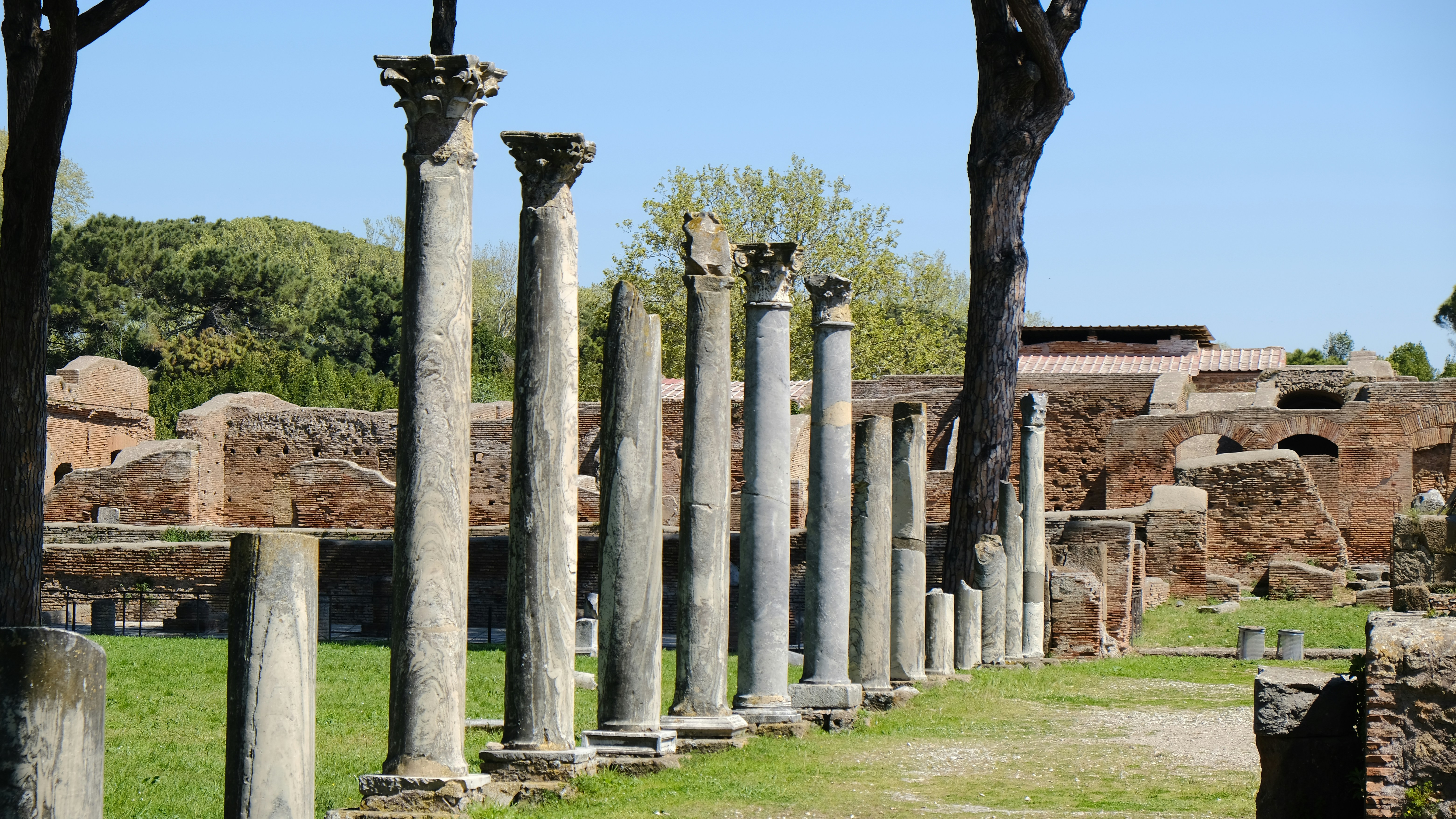 a row of stone pillars in front of a building
