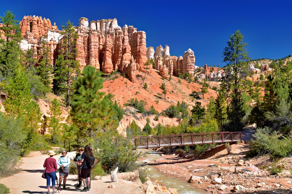 a group of people standing next to a river