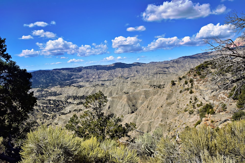 a scenic view of a mountain range with a blue sky