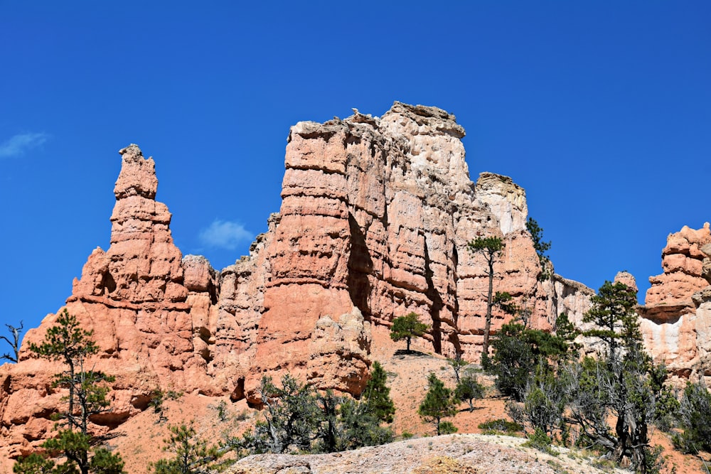 a group of tall rocks sitting on top of a mountain