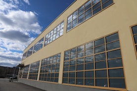 a building with many windows and a sky background