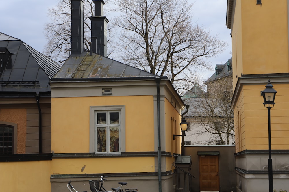 a bicycle parked in front of a yellow building