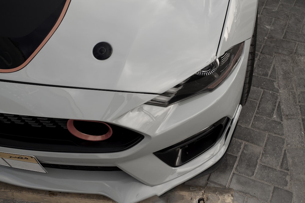 a close up of the front of a white sports car