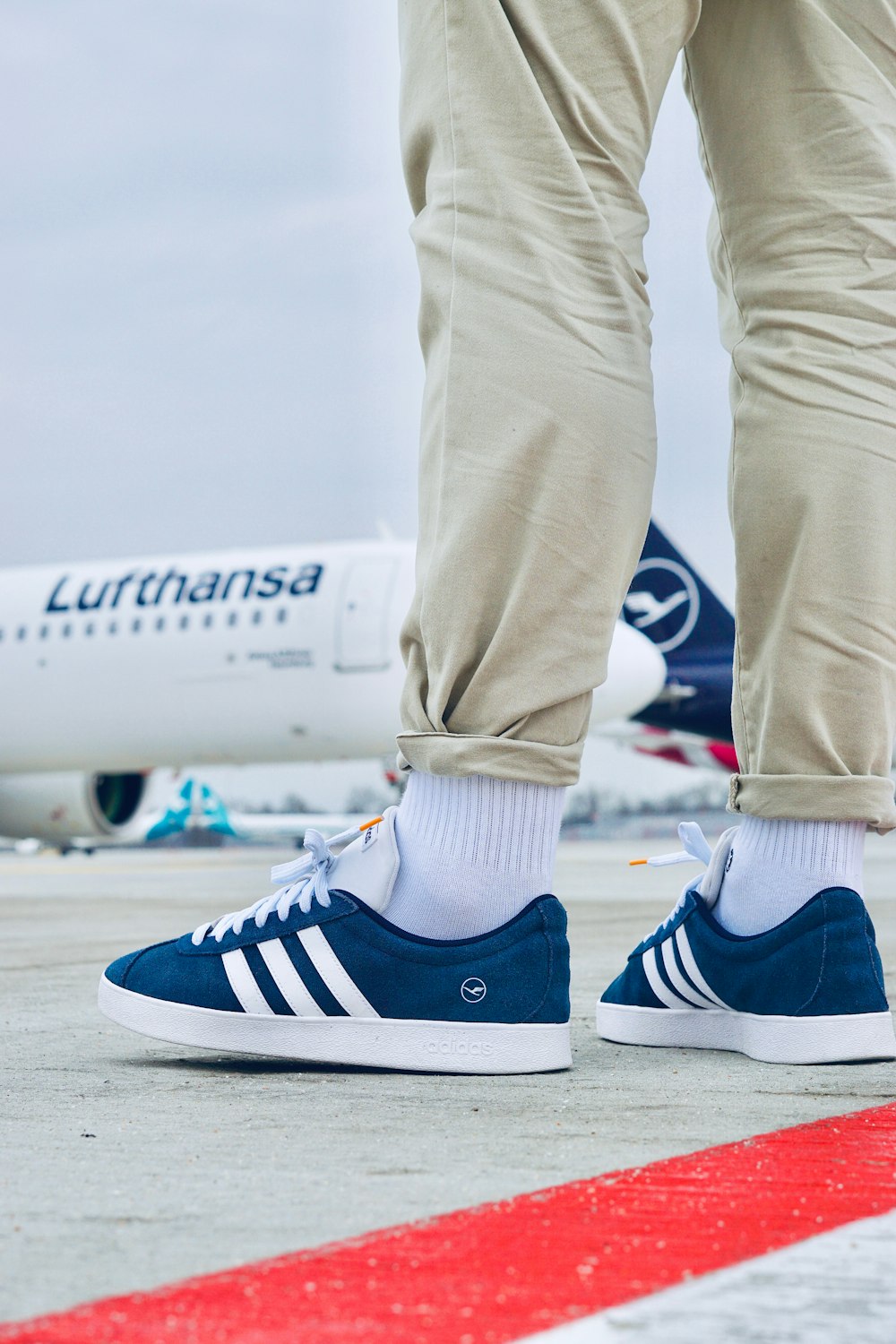 a person standing on a runway with their feet on the ground