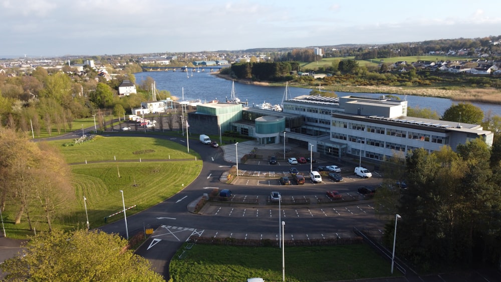 an aerial view of a parking lot next to a body of water