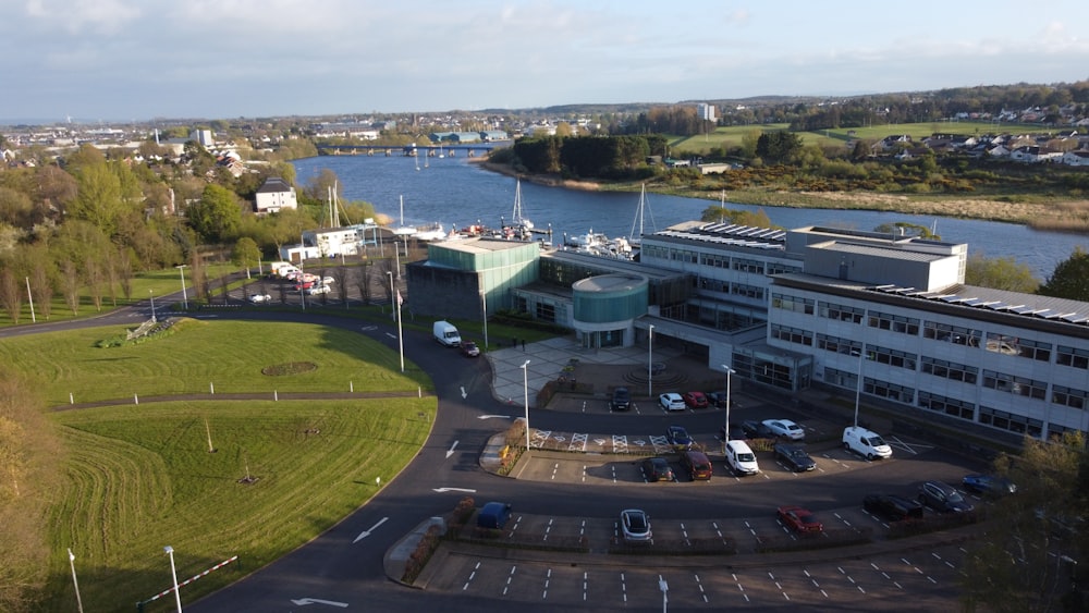 an aerial view of a parking lot next to a body of water