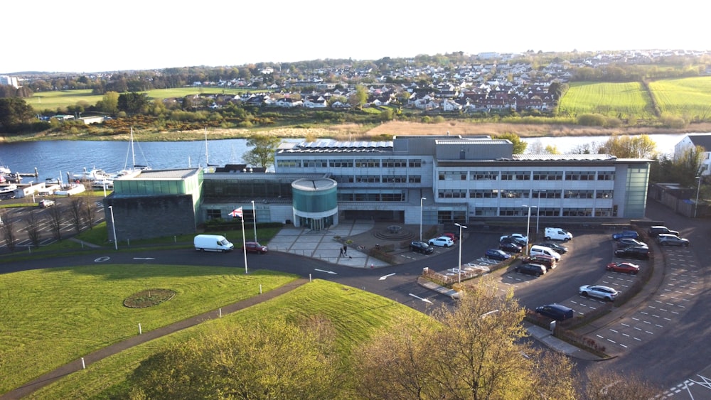 an aerial view of a building with cars parked in front of it