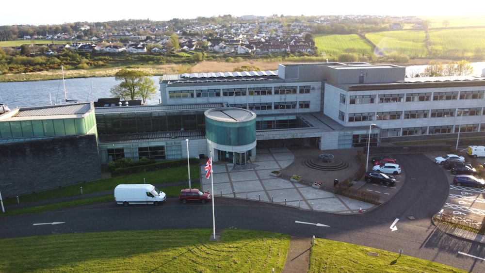 an aerial view of a building with cars parked in front of it