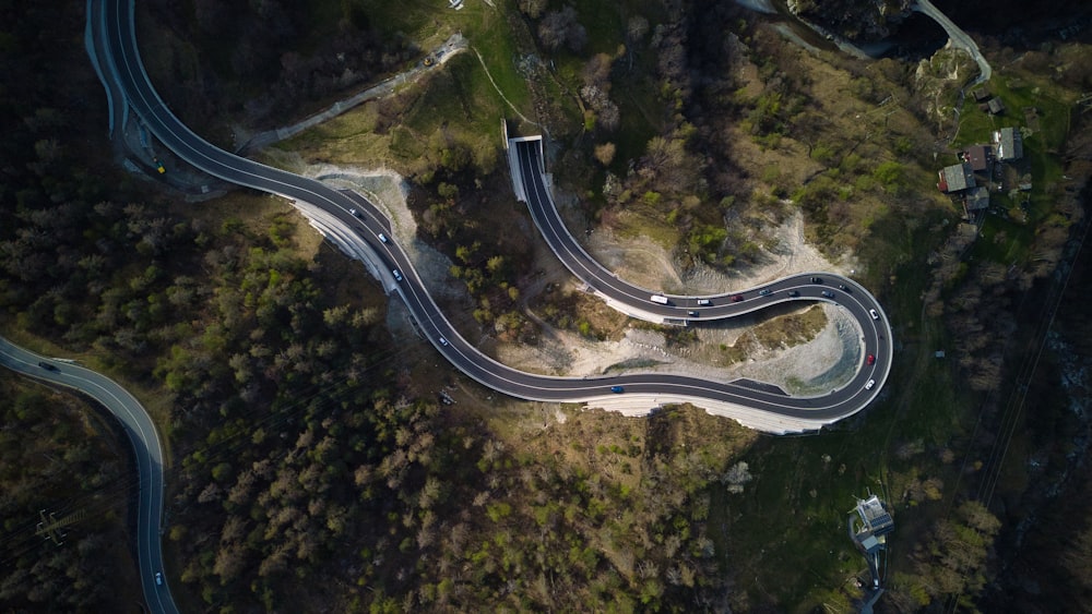 an aerial view of a winding road in the mountains