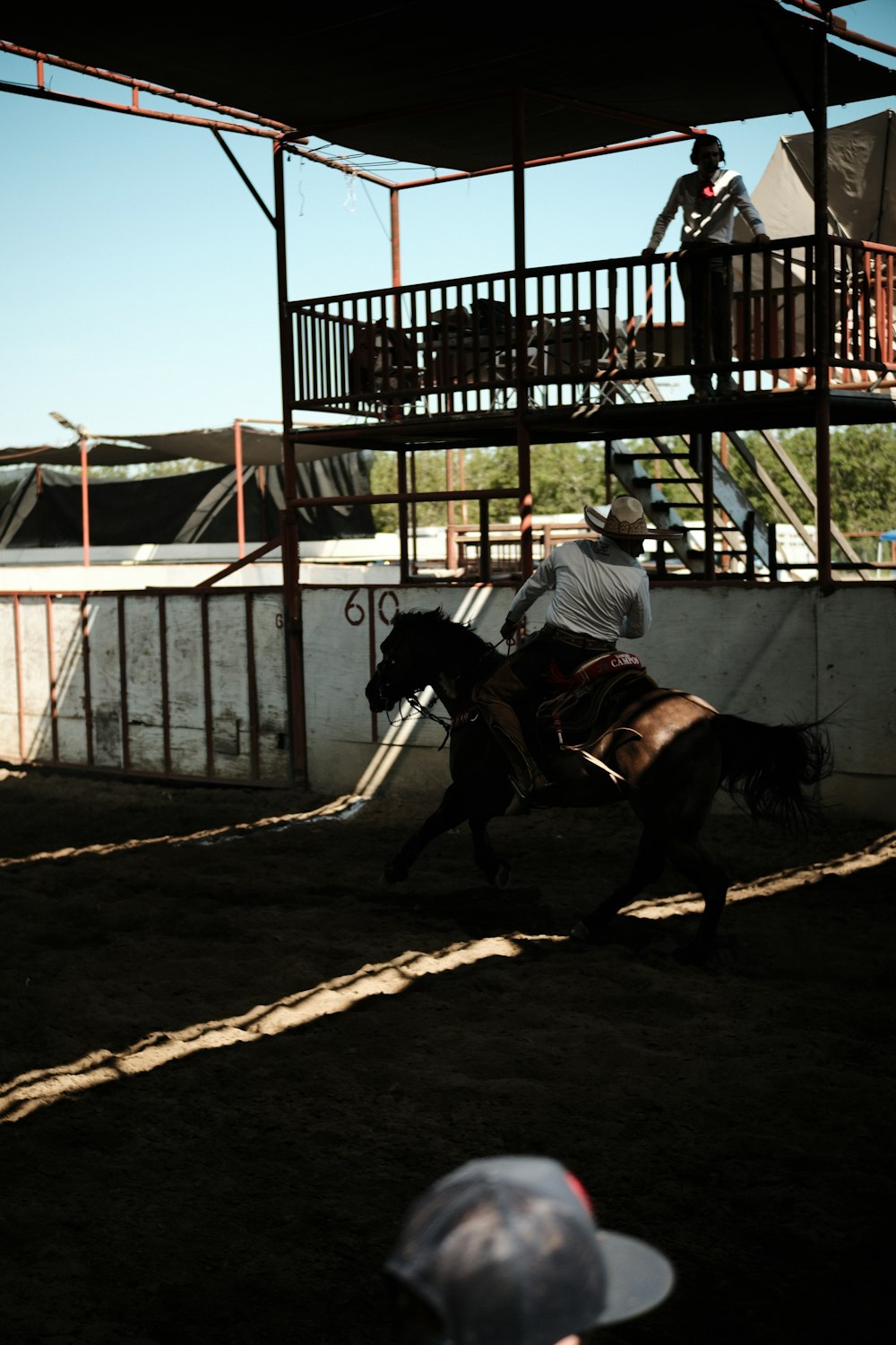 a man riding on the back of a brown horse