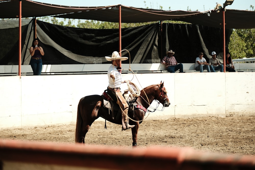 a man riding on the back of a brown horse