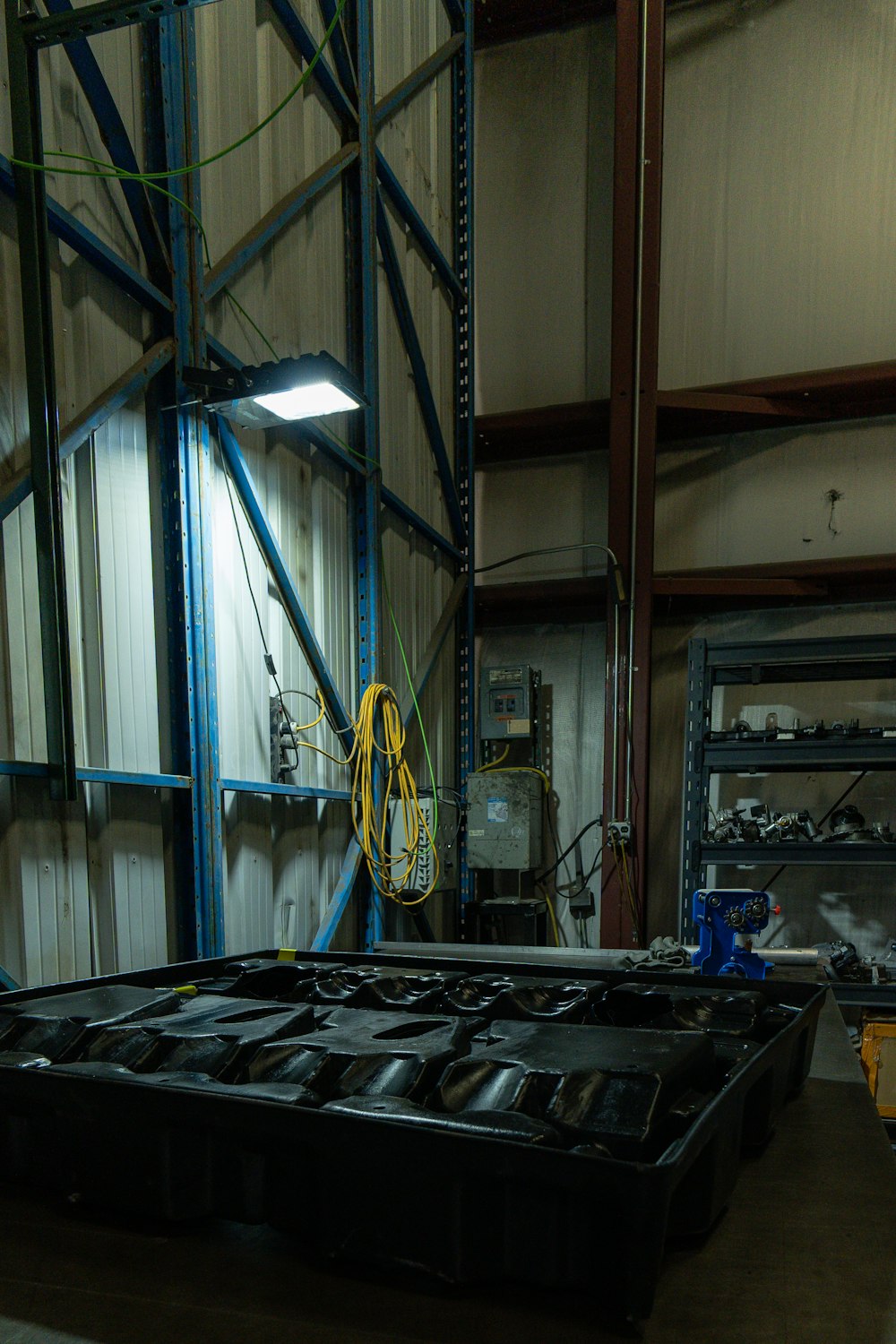 a warehouse filled with lots of black plastic containers