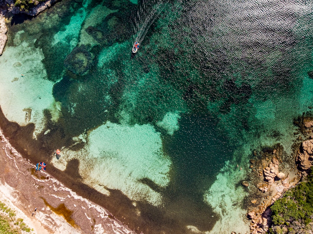 an aerial view of a boat in the water
