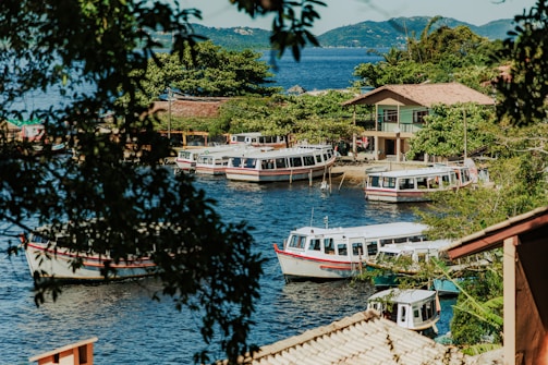 a group of boats floating on top of a river