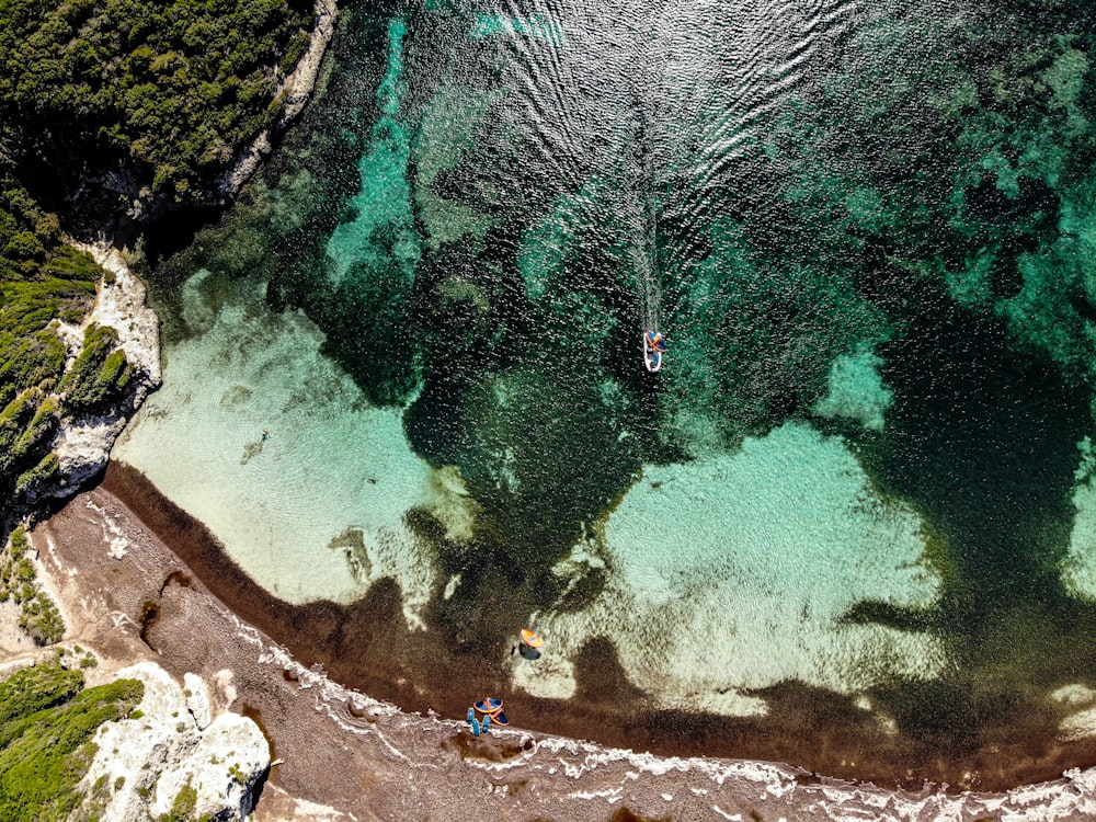 an aerial view of a boat in a body of water