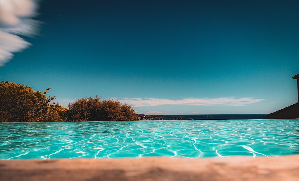 a swimming pool with a gazebo in the background