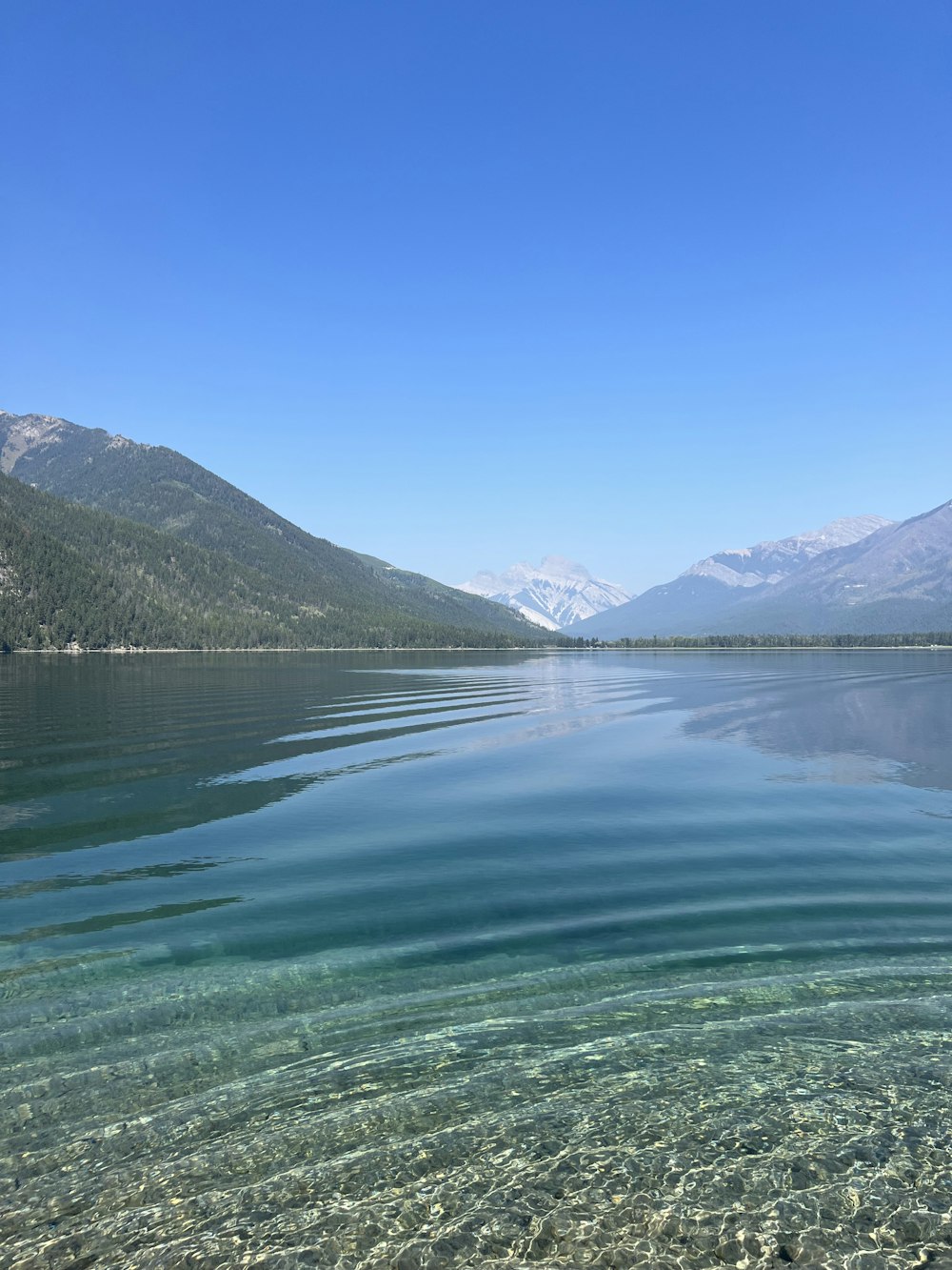 a body of water with mountains in the background